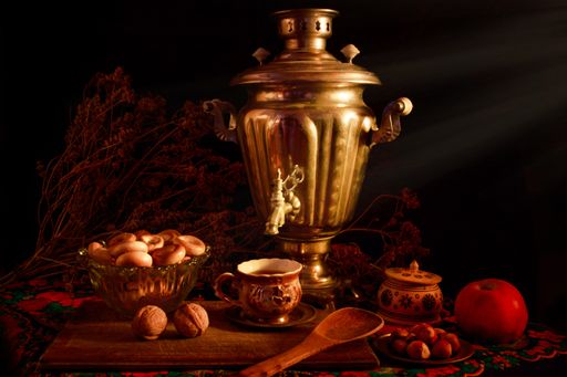 A closeup shot of a samovar in a beautiful interior setting on a black background