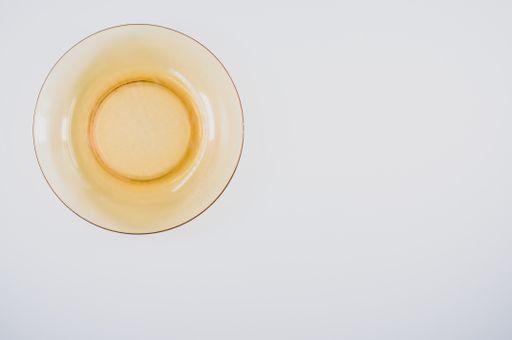 A high angle shot of an empty plate on a light blue surface