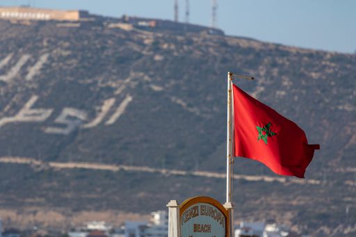 A close up shot of a Moroccan flag in Agadir, Morocco with beautiful hill background