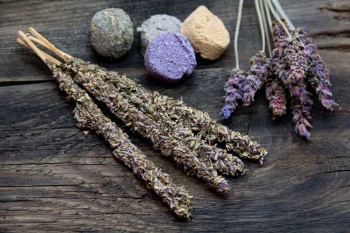 Dried lavender sticks and bath bombs on rustic wooden background, showcasing natural spa elements.