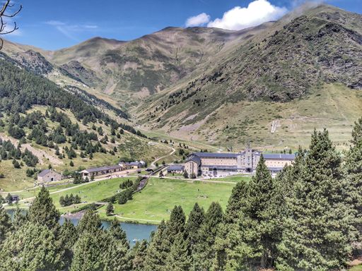 The beautiful view of the valley and mountains covered by pine trees. Vall de Nuria, Spain.
