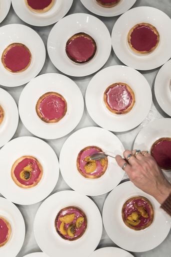 An overhead shot of different dishes with a person's hand holding a fork
