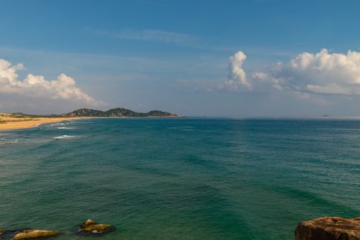 A sea with mountains in the distance in Vietnam