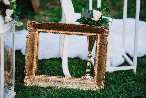 A decorative painting frame on the grass during the wedding ceremony