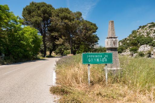 The road sign, entering the Province of Granada, borders Malaga Granada, Andalusia, Spain