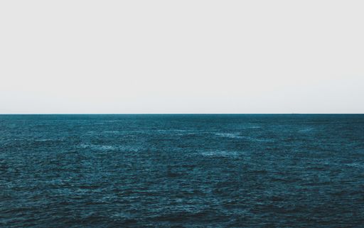 The mesmerizing view of the calm ocean under the blue sky - perfect for background