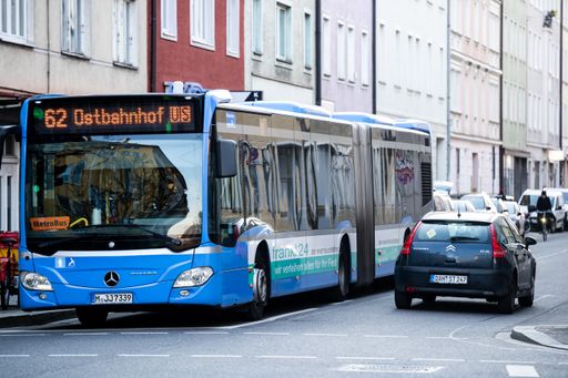 City bus on empty lane. Hardly any traffic in Munich city centre. Buses transport commuters and tourists through Bavarian city