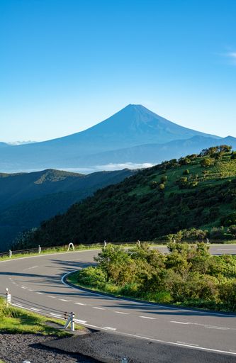 A silhouette of a mountain near the road in the morning