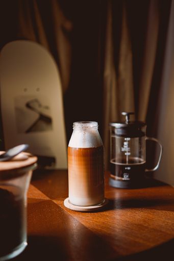 A vertical of coffee under sunlight on the table