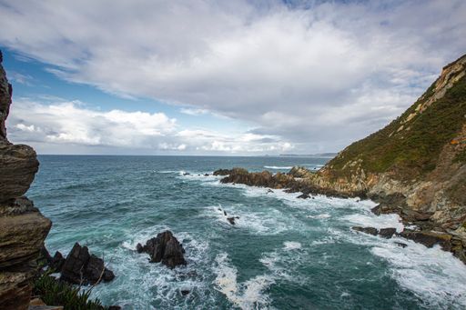 A shot of a view of seaside cliffs and wavy sea in Asturias, Northern Spain