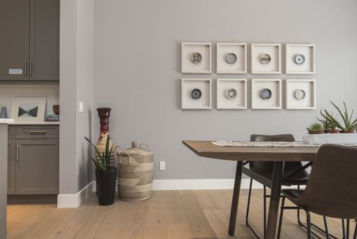 An interior shot of a modern house dining room with art on the wall
