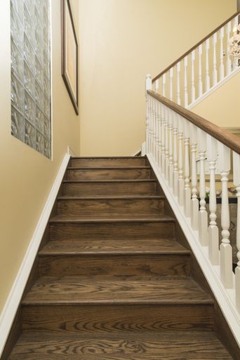 An interior vertical shot of a modern house wooden staircase