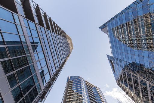 A low angle shot of blue high rise buildings