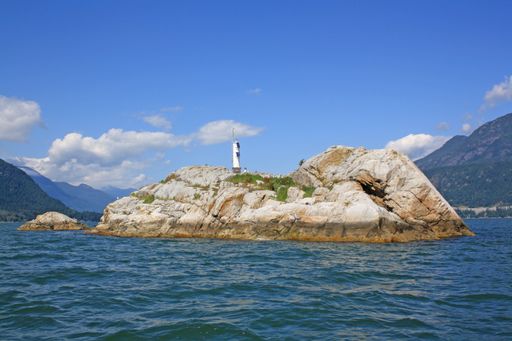 A shot of a rocky island in the middle of the sea in Vancouver, Canada