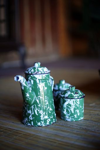 A vertical shot of an old porcelain tea set on a wooden surface