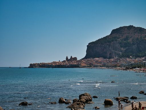 A Beautiful view of sea cost of Cefalu city in Italy in the morning with magic blue sky and green mountain