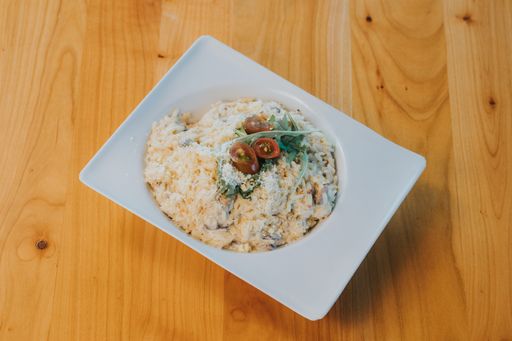 A high angle shot of risotto in a fancy plate on a table
