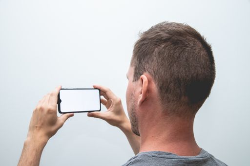 A closeup shot of a handsome man with a smartphone