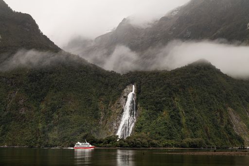 A cruise ship in front of the Bowen Falls in Milford Sound, New Zealand