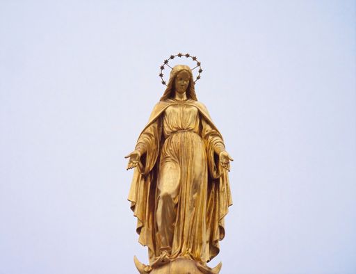 A low angle shot of the holy Mary statue on a column in front of the Zagreb cathedral in Croatia