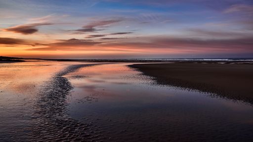 A wide shot of the beautiful coast of the sea with the amazing cloudy sky during golden hour