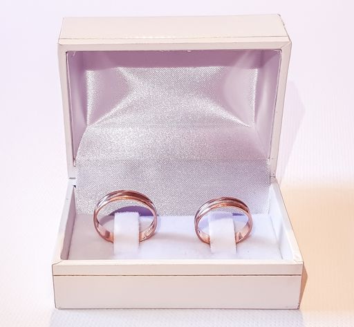 A white fancy box of two golden rings isolated on the white background