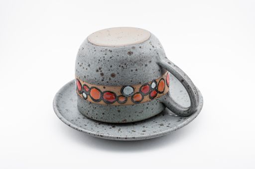 A horizontal shot of a Cappuccino Cup in three different position. Cup with Saucer