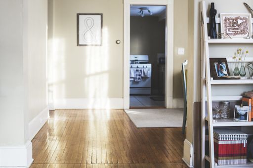 An indoor shot of a hallway and a shelf filled with random items