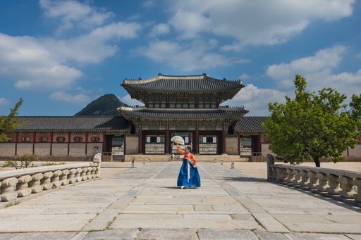 A South Korean young woman in traditional Hanbok dress in Gyeongbokgung Palace, Seoul, South Korea