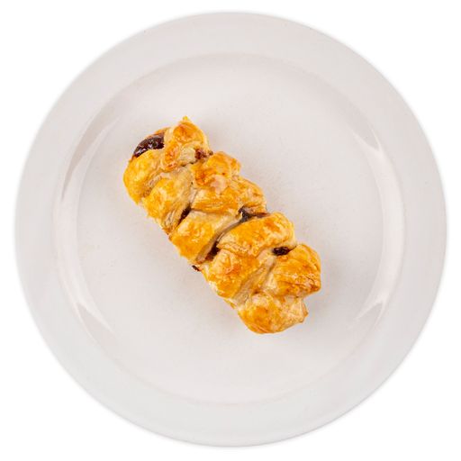 An overhead shot of a stuffed braid bread on a plate isolated on white background
