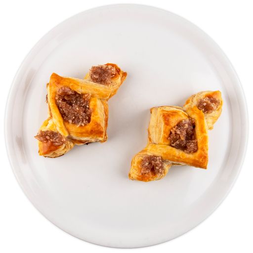 A top view of a cookie with a jam inside served on a white plate isolated on a white background