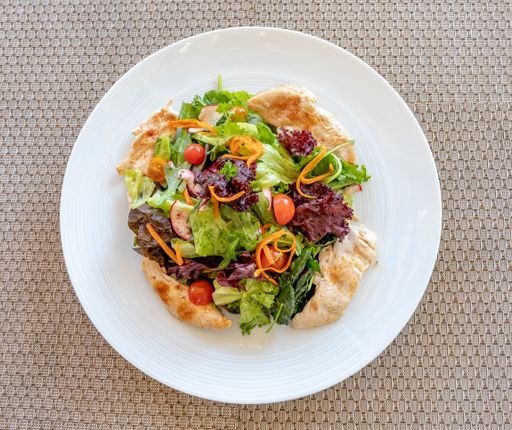 An overhead shot of a healthy Caesar salad on a white plate