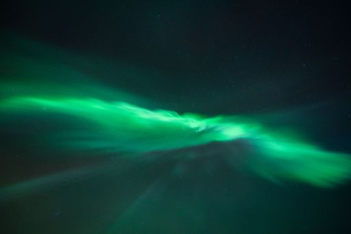 A mesmerizing display of the Northern Lights illuminating the night sky with vibrant green hues.