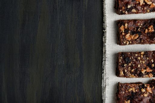 The pieces of chocolate brownie on white scarf- concept for healthy food during quarantine at home