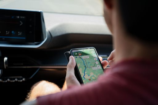 A Man checking a map on google maps on his smartphone while travelling through Portugal on holiday