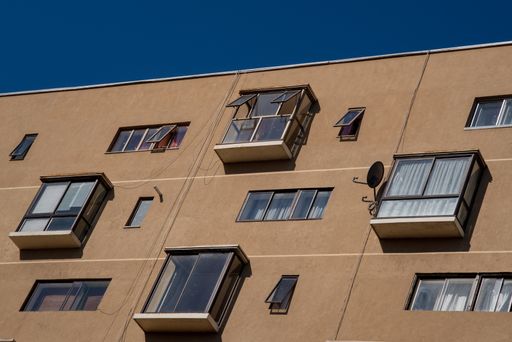 A low angle shot of a building with balconies during the daytime