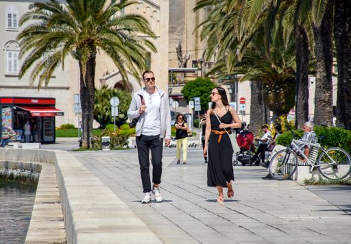 A young couple of tourists walking on the seafront promenade in Split, Croatia