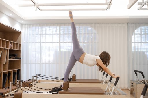A beautiful Korean female doing stretching in a dancing studio