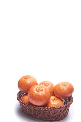 A basket full of tangerines isolated on a white background with free space for text