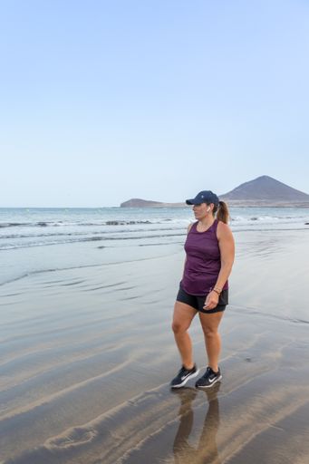 A Spanish female in sportswear on a morning run along the seashore, Santa Cruz de Tenerife, Spain