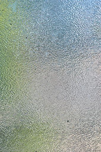 A vertical shot of a textured grey window background