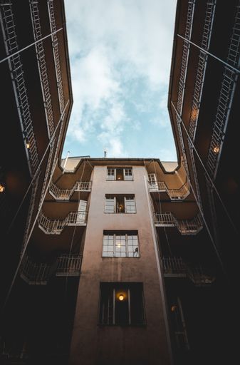 A vertical low angle shot of a high building with the sky in the background