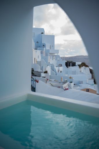 A vertical shot of the view of white buildings from a hotel in Santorini in the Aegean Sea