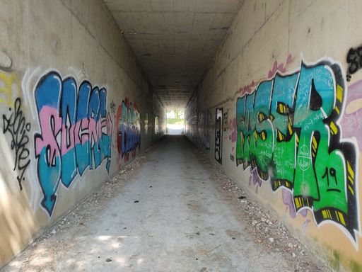 A tunnel entrance with graffiti in Grado, Asturias, Spain