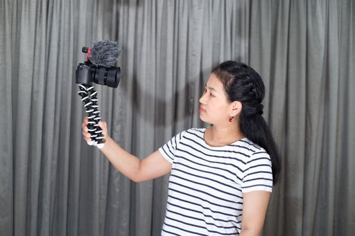A beautiful woman taking a self-photo with a camera