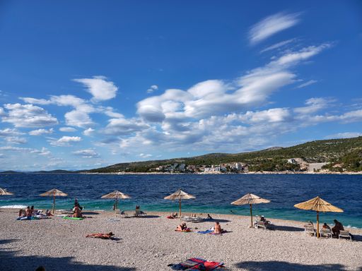 The tourists enjoying the beach in Primosten, Croatia at the Adriatic Sea