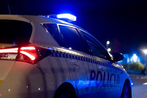 A closeup shot of the police car on the street at night