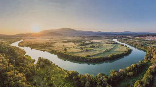 An aerial view of an amazing landscape at sunset under the blue sky
