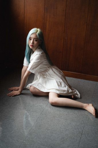 An attractive blue-haired South Korean female posing on the floor