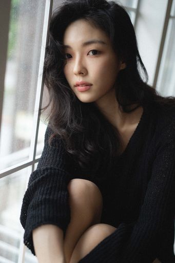 A beautiful South Korean female sitting on the windowsill